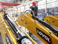 Workers are working on the production line at LOVOL Co in Qingdao, Shandong Province, China, on May 9, 2024. (