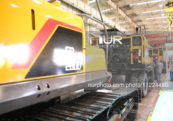 Workers are working on the production line at LOVOL Co in Qingdao, Shandong Province, China, on May 9, 2024. 