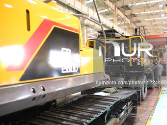 Workers are working on the production line at LOVOL Co in Qingdao, Shandong Province, China, on May 9, 2024. (