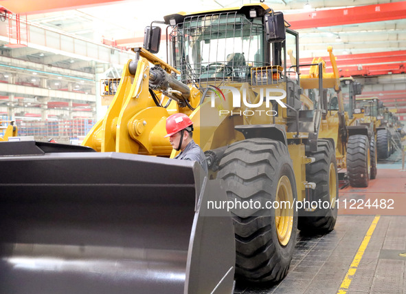 Workers are working on the production line at LOVOL Co in Qingdao, Shandong Province, China, on May 9, 2024. 