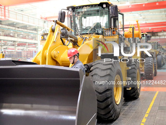 Workers are working on the production line at LOVOL Co in Qingdao, Shandong Province, China, on May 9, 2024. (