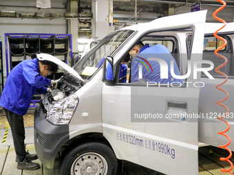 Workers are assembling cars at a vehicle production line at the Qingdao branch of SAIC-GM-Wuling Automobile Co in Qingdao, Shandong Province...