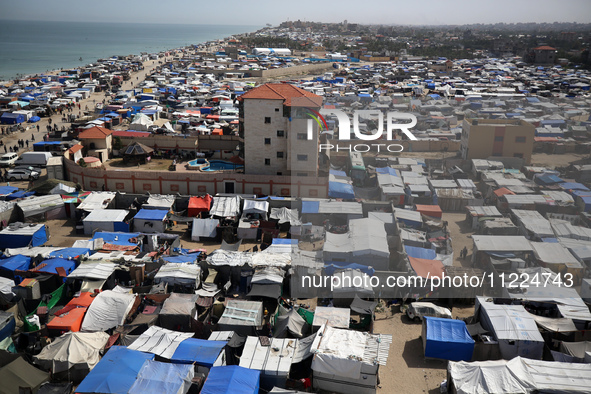 Tents housing internally displaced Palestinians are crowding the beach and the Mediterranean shoreline in Deir el-Balah in the central Gaza...