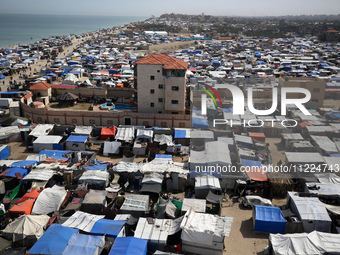 Tents housing internally displaced Palestinians are crowding the beach and the Mediterranean shoreline in Deir el-Balah in the central Gaza...