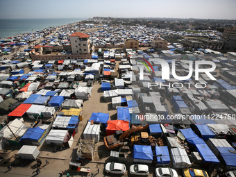 Tents housing internally displaced Palestinians are crowding the beach and the Mediterranean shoreline in Deir el-Balah in the central Gaza...