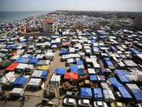 Tents housing internally displaced Palestinians are crowding the beach and the Mediterranean shoreline in Deir el-Balah in the central Gaza...