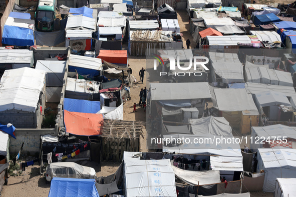 Tents housing internally displaced Palestinians are crowding the beach and the Mediterranean shoreline in Deir el-Balah in the central Gaza...