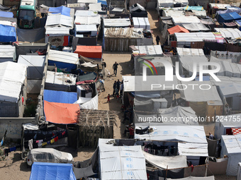 Tents housing internally displaced Palestinians are crowding the beach and the Mediterranean shoreline in Deir el-Balah in the central Gaza...