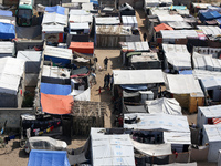 Tents housing internally displaced Palestinians are crowding the beach and the Mediterranean shoreline in Deir el-Balah in the central Gaza...