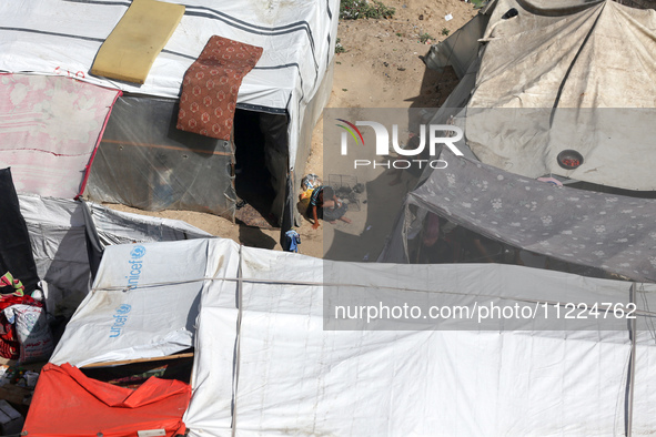 Tents housing internally displaced Palestinians are crowding the beach and the Mediterranean shoreline in Deir el-Balah in the central Gaza...