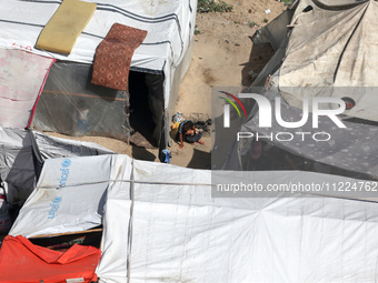 Tents housing internally displaced Palestinians are crowding the beach and the Mediterranean shoreline in Deir el-Balah in the central Gaza...