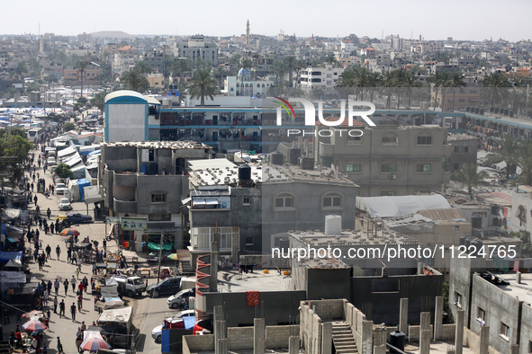 Tents housing internally displaced Palestinians are crowding the beach and the Mediterranean shoreline in Deir el-Balah in the central Gaza...