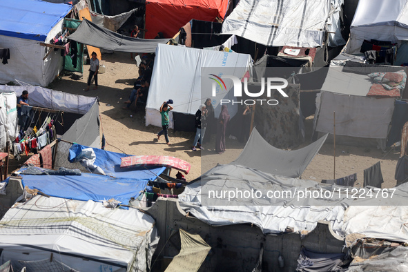 Tents housing internally displaced Palestinians are crowding the beach and the Mediterranean shoreline in Deir el-Balah in the central Gaza...