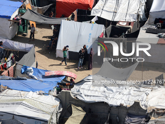 Tents housing internally displaced Palestinians are crowding the beach and the Mediterranean shoreline in Deir el-Balah in the central Gaza...