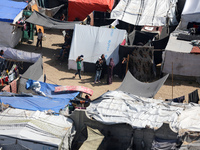 Tents housing internally displaced Palestinians are crowding the beach and the Mediterranean shoreline in Deir el-Balah in the central Gaza...