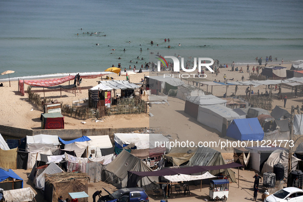 Tents housing internally displaced Palestinians are crowding the beach and the Mediterranean shoreline in Deir el-Balah in the central Gaza...