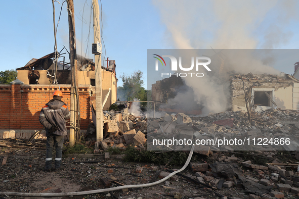 An electrician is looking at the damage caused by a Russian missile attack in Kharkiv, northeastern Ukraine, on May 10, 2024. During the nig...