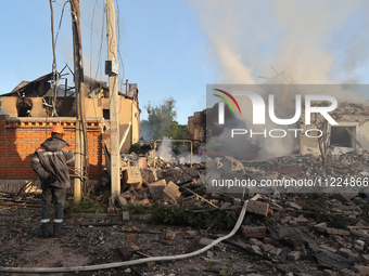 An electrician is looking at the damage caused by a Russian missile attack in Kharkiv, northeastern Ukraine, on May 10, 2024. During the nig...