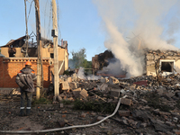 An electrician is looking at the damage caused by a Russian missile attack in Kharkiv, northeastern Ukraine, on May 10, 2024. During the nig...