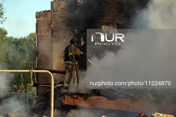 A firefighter is suppressing a fire caused by a Russian missile attack in Kharkiv, northeastern Ukraine, on May 10, 2024. On the night of Ma...