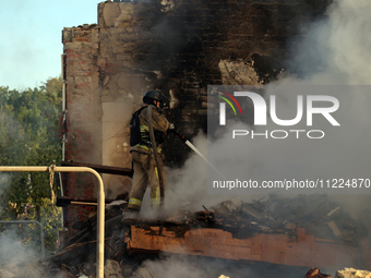 A firefighter is suppressing a fire caused by a Russian missile attack in Kharkiv, northeastern Ukraine, on May 10, 2024. On the night of Ma...