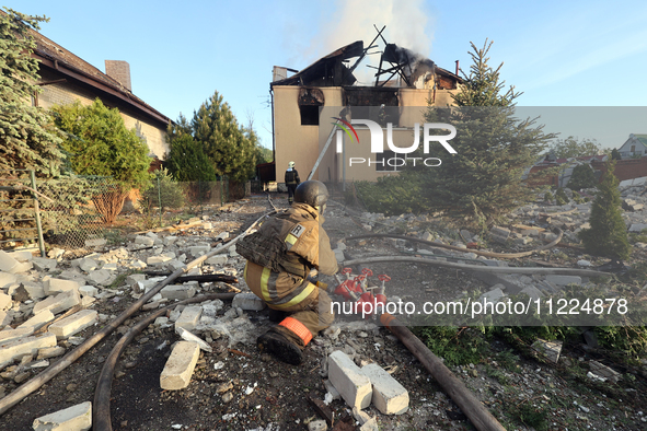 Rescuers are working at a house in Kharkiv, Ukraine, on May 10, 2024, after a Russian missile attack. During the night of May 10, Russian fo...