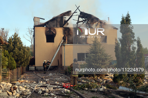 Rescuers are working at a house in Kharkiv, Ukraine, on May 10, 2024, after a Russian missile attack. During the night of May 10, Russian fo...