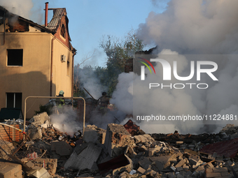 Rescuers are working at a house in Kharkiv, Ukraine, on May 10, 2024, after a Russian missile attack. During the night of May 10, Russian fo...