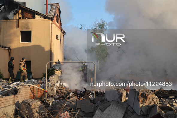 Rescuers are working at a house in Kharkiv, Ukraine, on May 10, 2024, after a Russian missile attack. During the night of May 10, Russian fo...