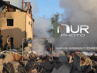 Rescuers are working at a house in Kharkiv, Ukraine, on May 10, 2024, after a Russian missile attack. During the night of May 10, Russian fo...