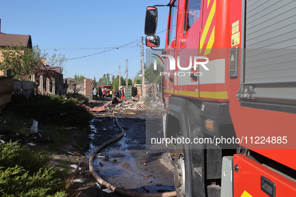 A fire engine is parking in the street affected by a Russian missile attack in Kharkiv, northeastern Ukraine, on May 10, 2024. During the ni...