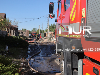 A fire engine is parking in the street affected by a Russian missile attack in Kharkiv, northeastern Ukraine, on May 10, 2024. During the ni...