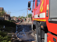 A fire engine is parking in the street affected by a Russian missile attack in Kharkiv, northeastern Ukraine, on May 10, 2024. During the ni...