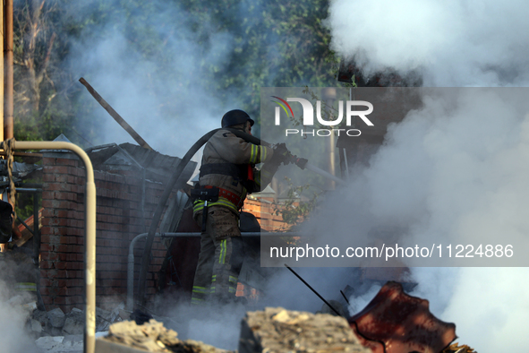 A firefighter is suppressing a fire caused by a Russian missile attack in Kharkiv, northeastern Ukraine, on May 10, 2024. On the night of Ma...