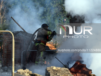 A firefighter is suppressing a fire caused by a Russian missile attack in Kharkiv, northeastern Ukraine, on May 10, 2024. On the night of Ma...