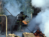 A firefighter is suppressing a fire caused by a Russian missile attack in Kharkiv, northeastern Ukraine, on May 10, 2024. On the night of Ma...