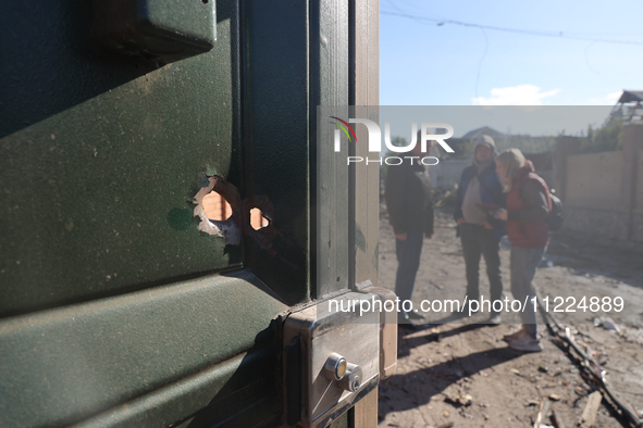 A hole is being seen in the door after a Russian missile attack in Kharkiv, northeastern Ukraine, on May 10, 2024. On the night of May 10, R...