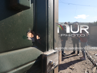 A hole is being seen in the door after a Russian missile attack in Kharkiv, northeastern Ukraine, on May 10, 2024. On the night of May 10, R...