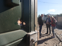 A hole is being seen in the door after a Russian missile attack in Kharkiv, northeastern Ukraine, on May 10, 2024. On the night of May 10, R...