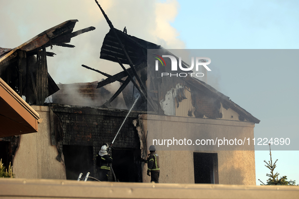 Rescuers are working at a house in Kharkiv, Ukraine, on May 10, 2024, after a Russian missile attack. During the night of May 10, Russian fo...