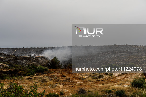 Smoke is rising as the fire continues to burn in Limassol, Cyprus, on May 10, 2024. The wildfire, which broke out yesterday, is burning most...