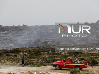 Members of the fire department are preparing a drone to inspect the area for any resurgence of the wildfire in Limassol, Cyprus, on May 10,...