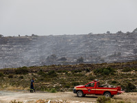 Members of the fire department are preparing a drone to inspect the area for any resurgence of the wildfire in Limassol, Cyprus, on May 10,...