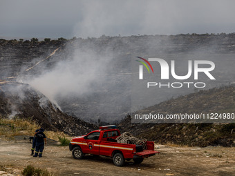 Members of the fire department are preparing a drone to inspect the area for any resurgence of the wildfire in Limassol, Cyprus, on May 10,...