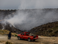 Members of the fire department are preparing a drone to inspect the area for any resurgence of the wildfire in Limassol, Cyprus, on May 10,...