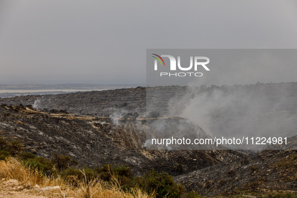 Smoke is rising as the fire continues to burn in Limassol, Cyprus, on May 10, 2024. The wildfire, which broke out yesterday, is burning most...