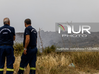 Members of the fire department are watching for possible resurgence in Limassol, Cyprus, on May 10, 2024. The wildfire, which broke out yest...