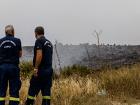 Members of the fire department are watching for possible resurgence in Limassol, Cyprus, on May 10, 2024. The wildfire, which broke out yest...