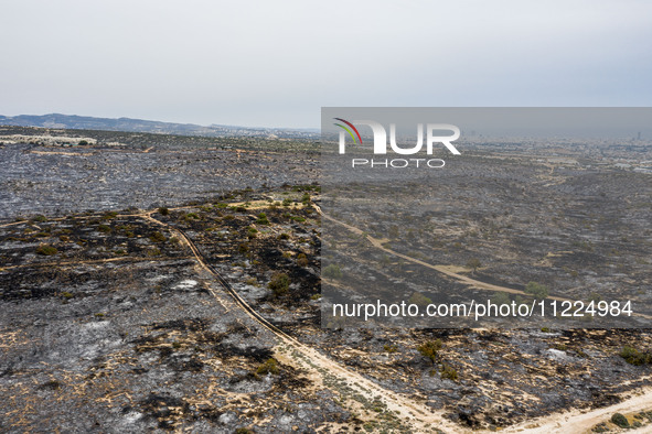 An aerial view shows the burned area in Limassol, Cyprus, on May 10, 2024. A wildfire is burning mostly wild vegetation over a six square ki...