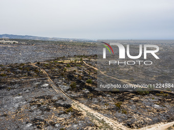 An aerial view shows the burned area in Limassol, Cyprus, on May 10, 2024. A wildfire is burning mostly wild vegetation over a six square ki...